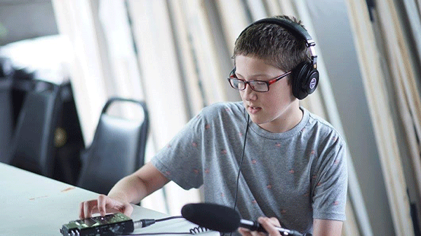 person wearing headphones and holding a microphone