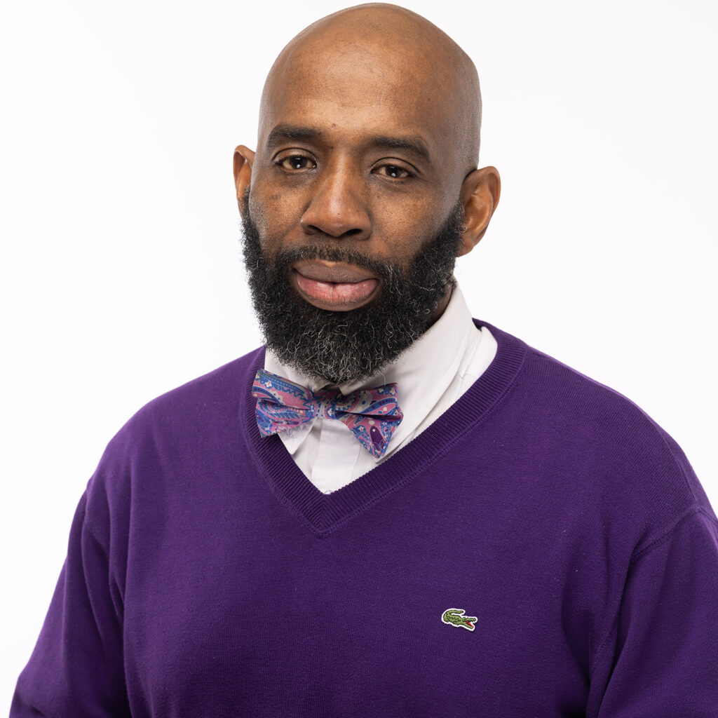 A headshot of Deacon Jerry Ford, who is wearing a purple sweater.