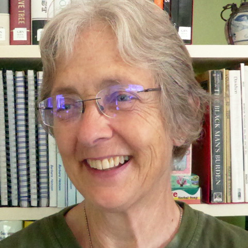 A headshot of Barbara Heinzen, who is wearing glasses and smiling for the camera.