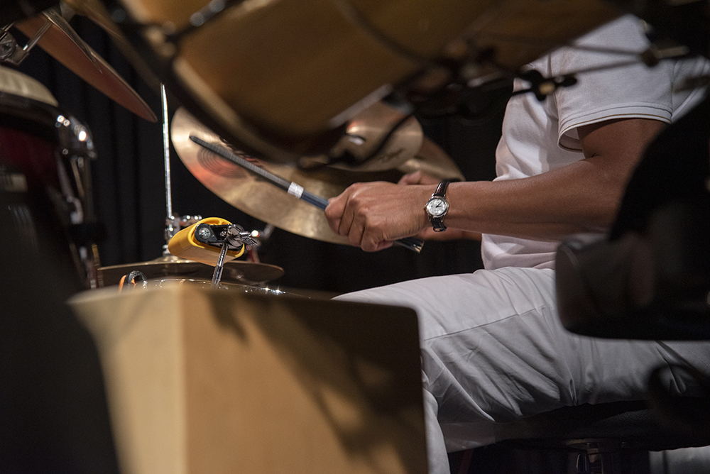 Gustavo Ovalles performing on the drums and other various percussion instruments.