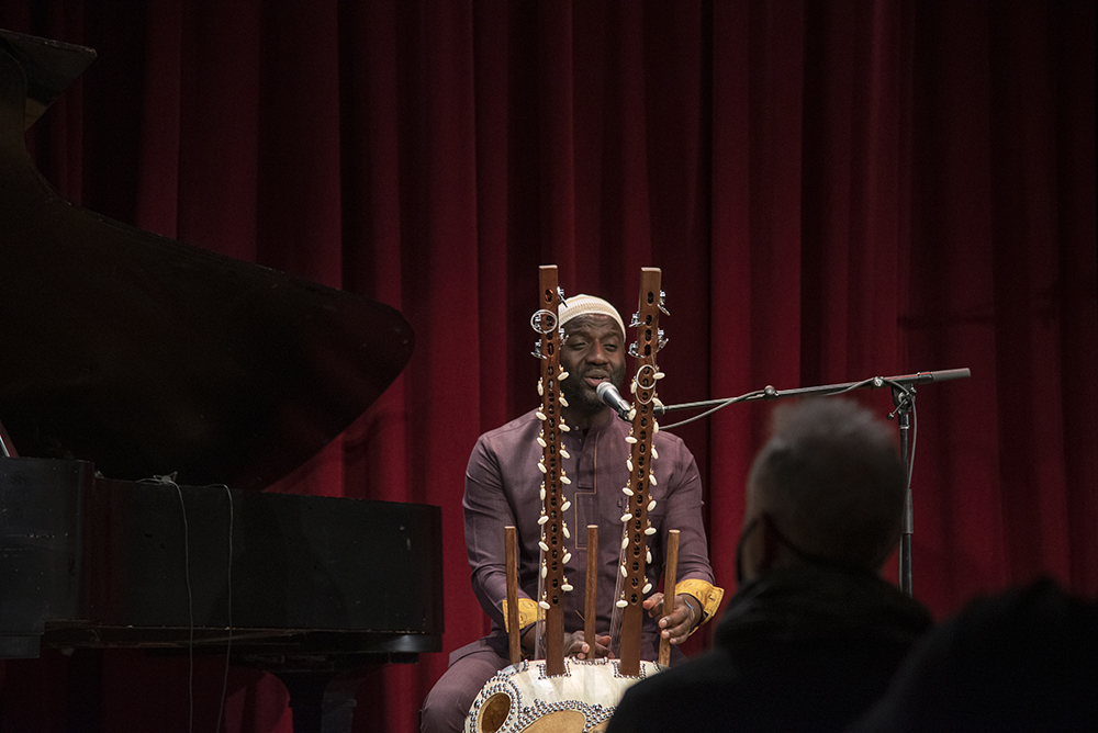 An action shot of Seckou Keita playing the Kora.