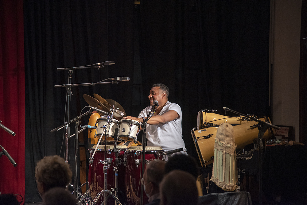 Gustavo Ovalles performing on the drums and other various percussion instruments.
