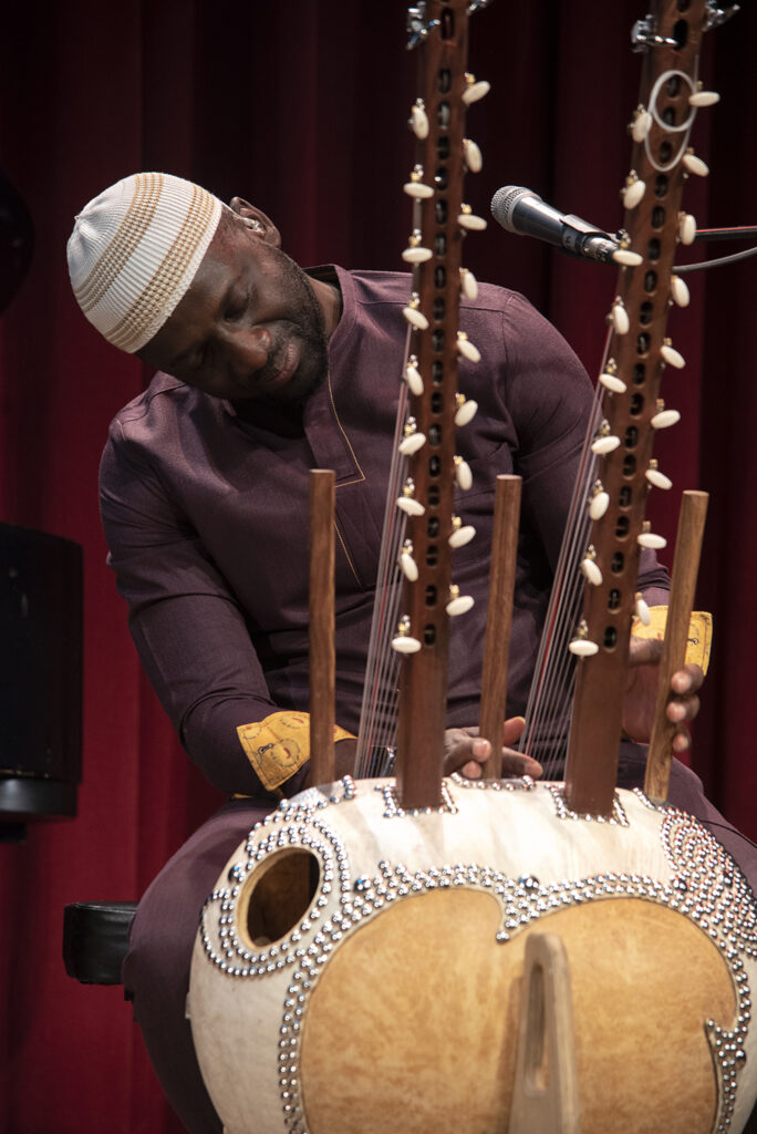 An action shot of Seckou Keita playing the Kora.