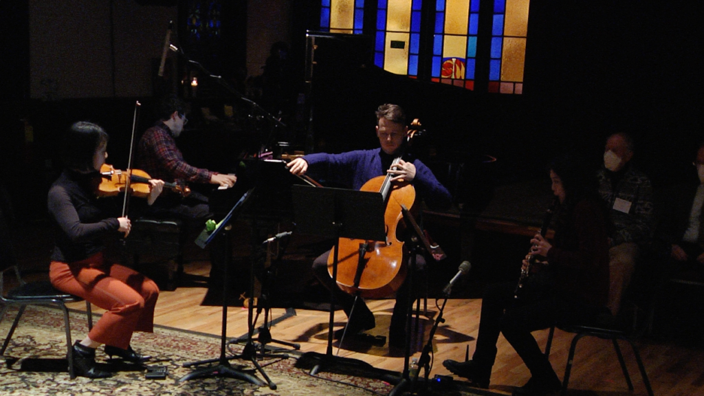 A group of musicians, varying in different string instruments, are playing music.