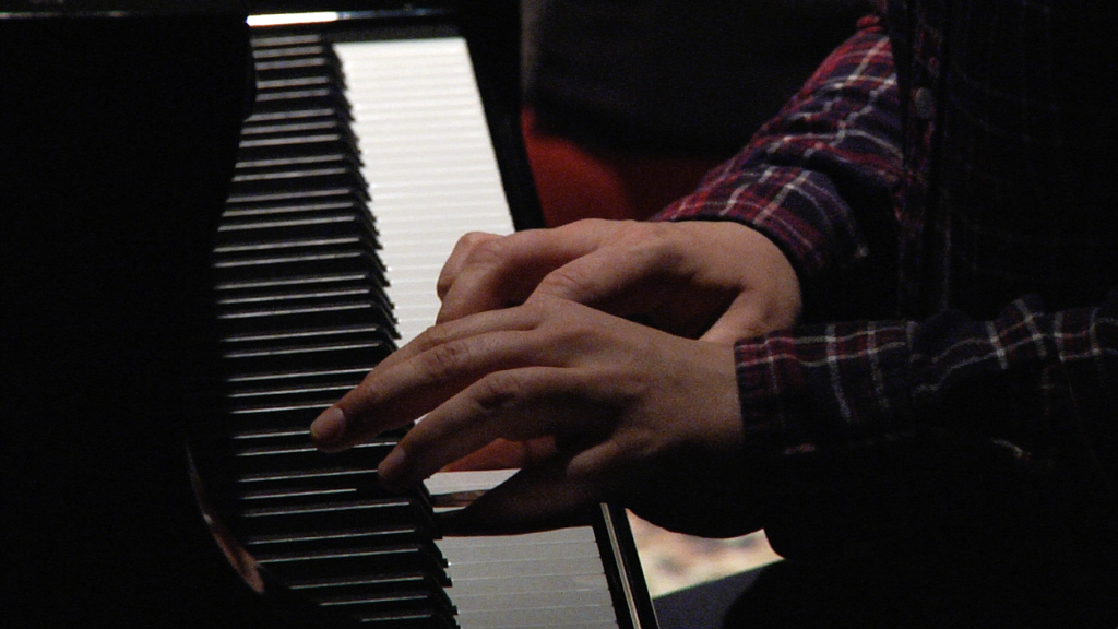 A close-up of someone playing the piano.