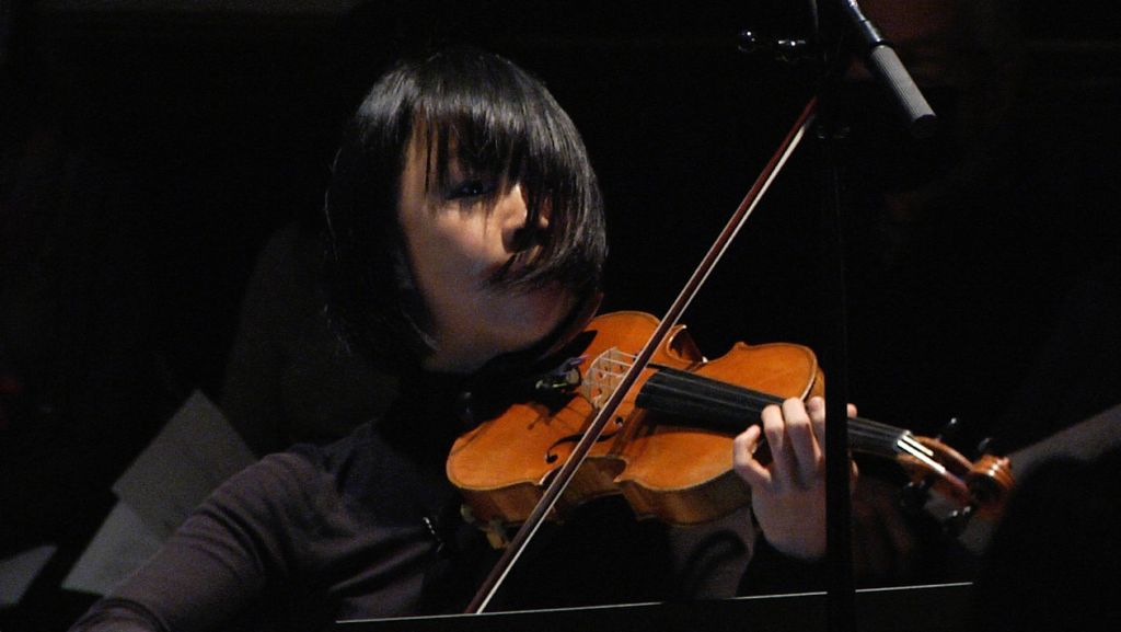 A front-facing image of someone playing the violin