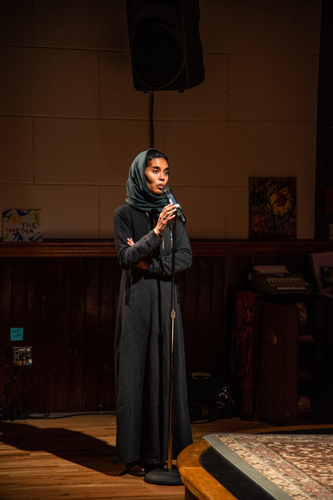 an audience member wearing a headscarf asks a question