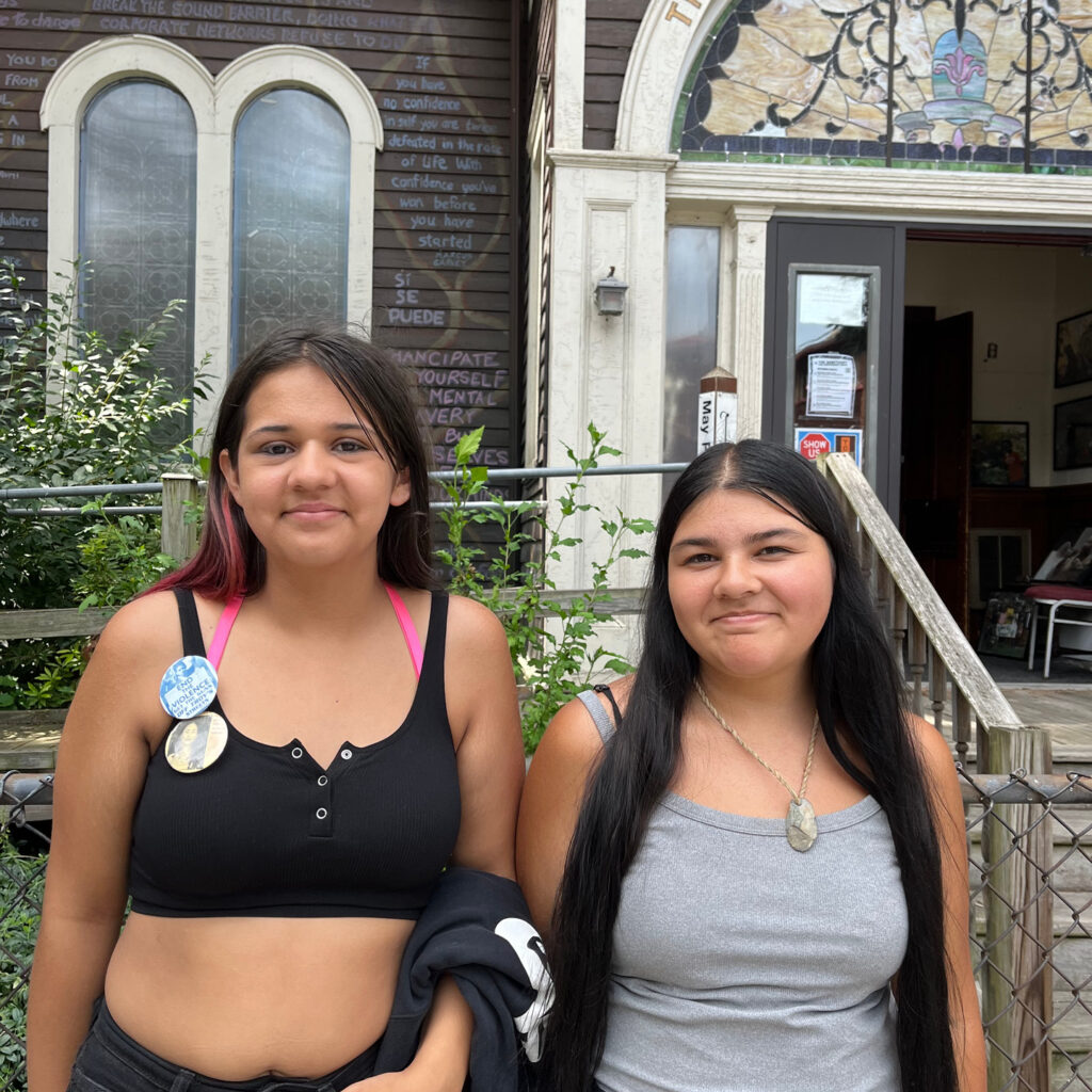 Two young women standing in front of The Sanctuary for Independent Media