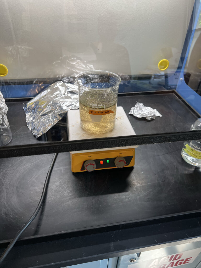 A beaker of slightly murky water warms up on a heating plate in the NATURE Lab. 