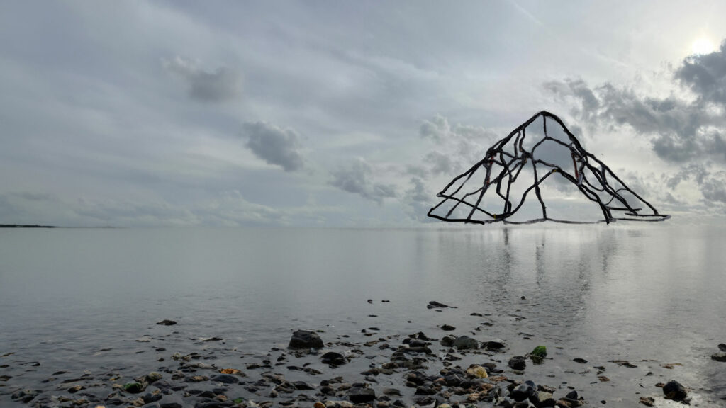 A composite image showing the bank of a body of water with rocls in the foreground and water disappearing into the horizon. Hovering over the water is a mountain like structure  with a sceleton of the shape