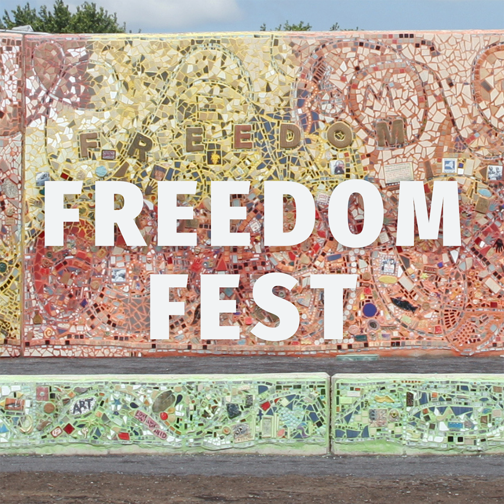 "Freedom Fest" in white capital letters over a photo of the newly built Freedom Square with mosaics, mirrors, tiles, and lot of color