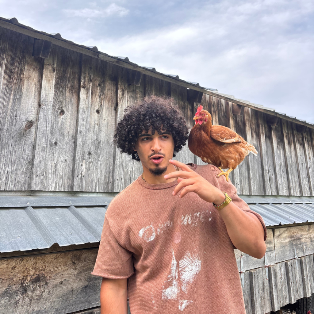 Emet Vitale-Penniman with a chicken on his shoulder