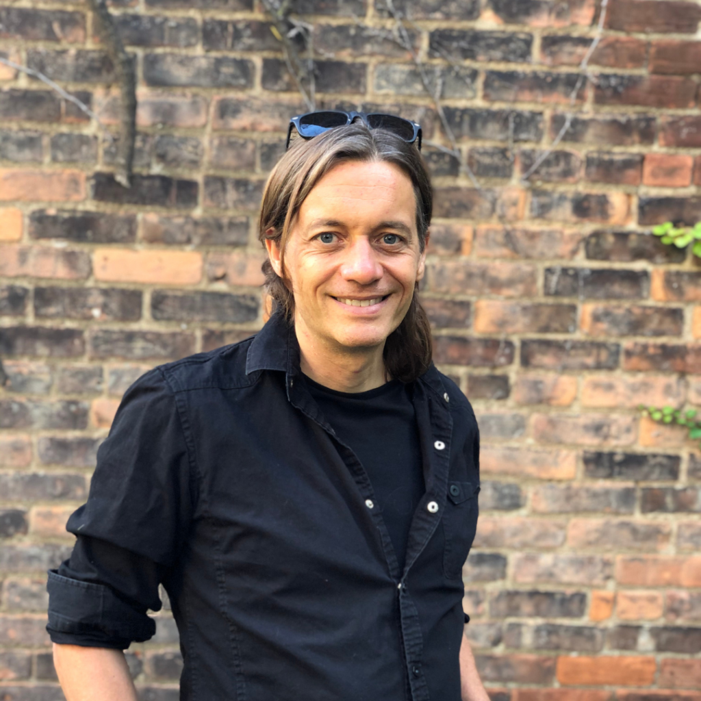 Scott Kellogg in front of a brick wall
